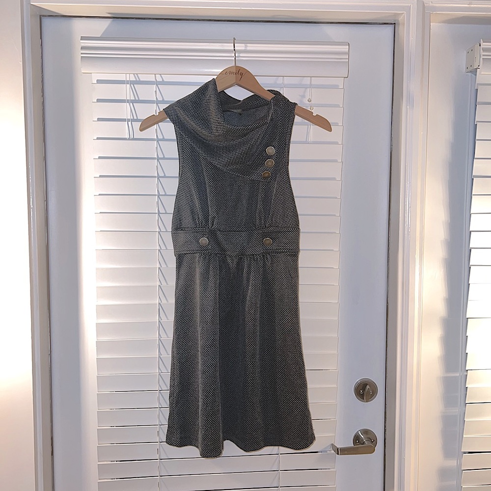 Sleeveless, patterned, mini dress with high neck. Colors are dark gray and black